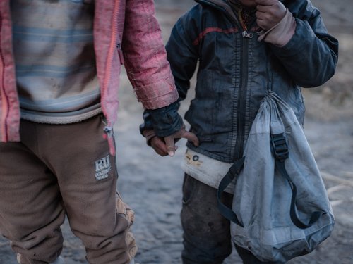 Two children in thin clothes, Dho Tarap. The village sits at roughly 3,900 m; October nights drop to −10 °C or below.