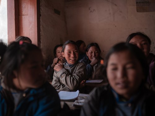 School students keep their jackets on inside class. Measured classroom temperatures hover 2–4 °C above ambient for most of the school day.