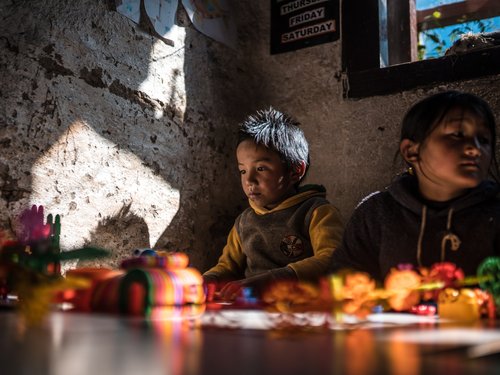 A single south window lights a classroom. Daylighting and solar gain share the same aperture — the design problem in miniature.