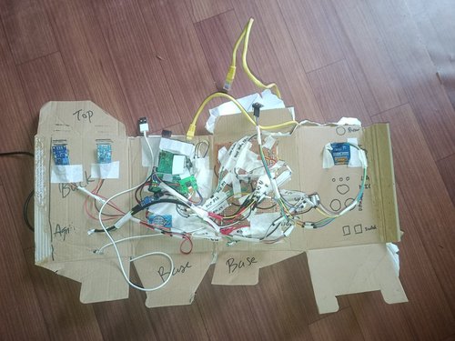 15 June — Designing the enclosure in cardboard first. Sensor zones marked by hand — Top, Agri, Base — with the real breakouts taped where they'll sit.