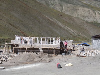 The hall on 24 September 2026: stone walls at window height, timber window frames set in.